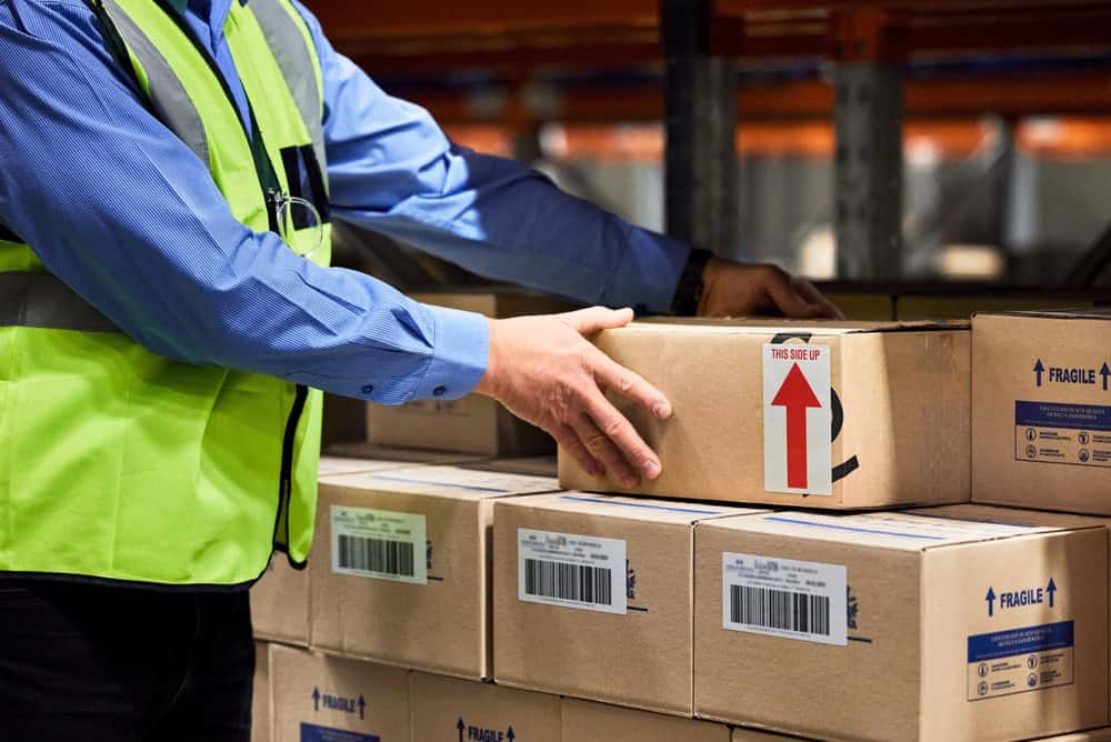 Warehouse worker handling a fragile shipping carton